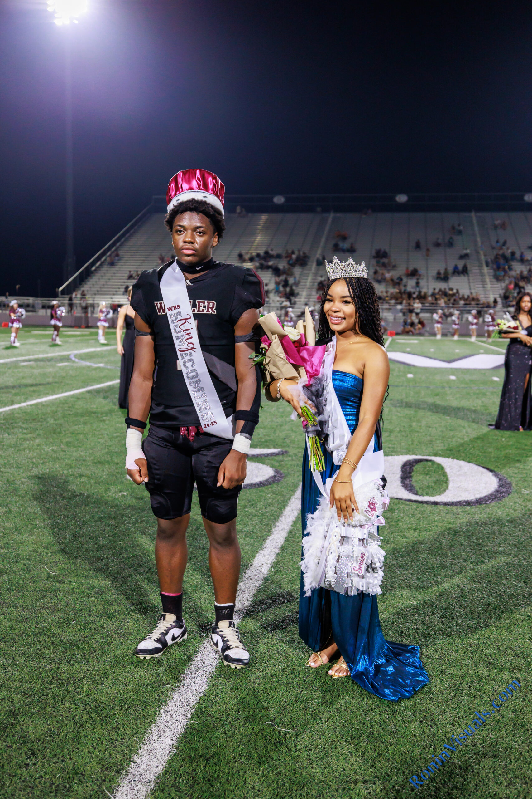 Homecoming King Thony Tshitenge and Queen Mattie Jones stand at the 50-yard line after being crowned during the halftime ceremony in Daikin Stadium on Sept. 13, 2024. The Waller Bulldog football team wins their first homecoming game in nearly a decade, over Houston Westside, for the Bulldog’s second victory of the 2024 campaign, at Daikin Stadium in Waller, Sept. 13, 2024. (Photo by Creighton Holub, courtesy RoninVisuals.com)