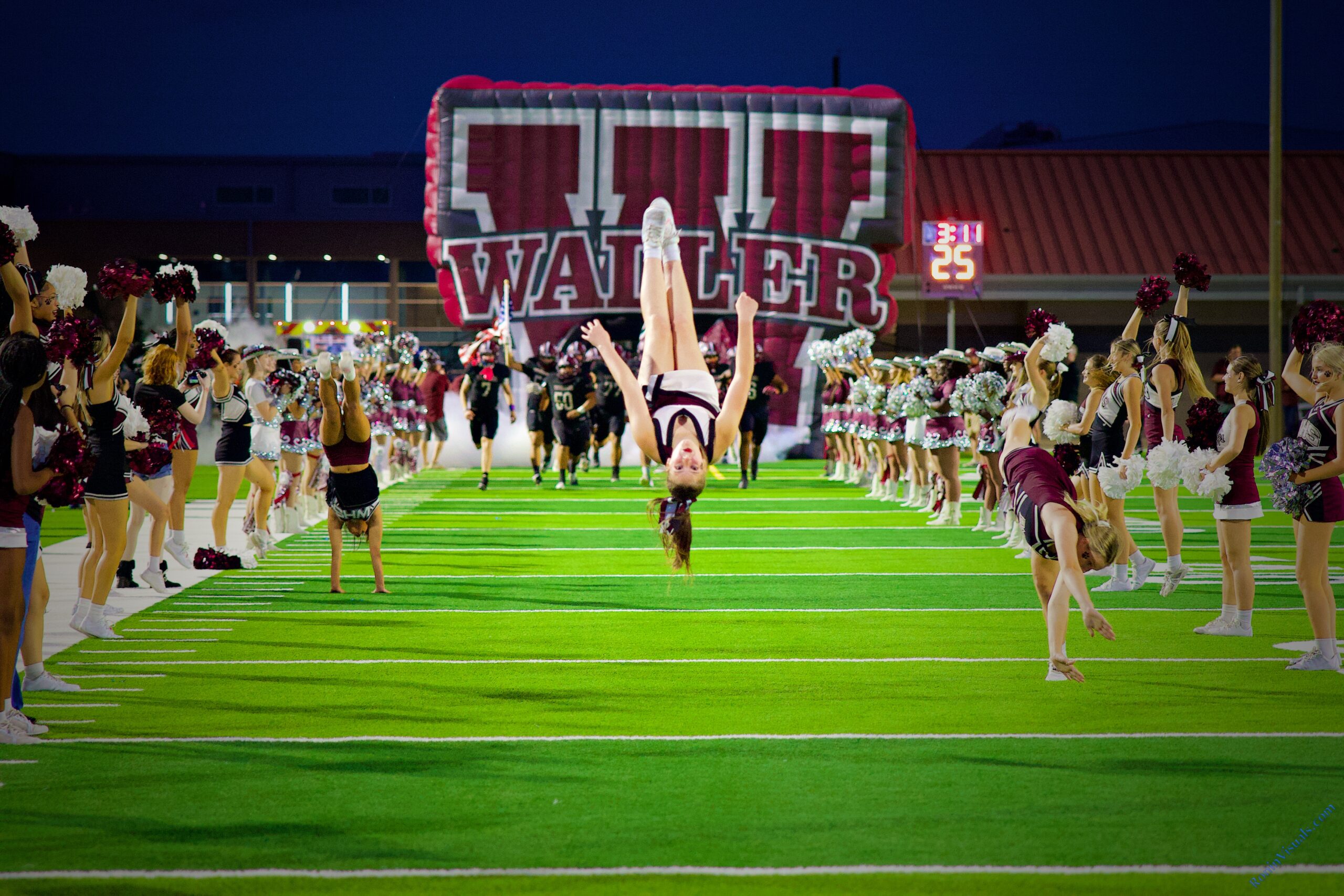 The Waller cheerleaders lead the football team onto the field at Daikin Stadium before their district victory over Langham Creek at Daikin Stadium, Oct. 24, 2025. (Ronin Visuals photo by Alberto Mata Jr., all rights reserved.)